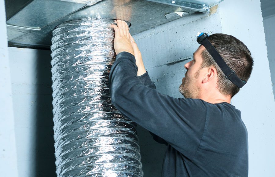 A professional technician from The Duct Kings using a state-of-the-art air duct cleaning machine