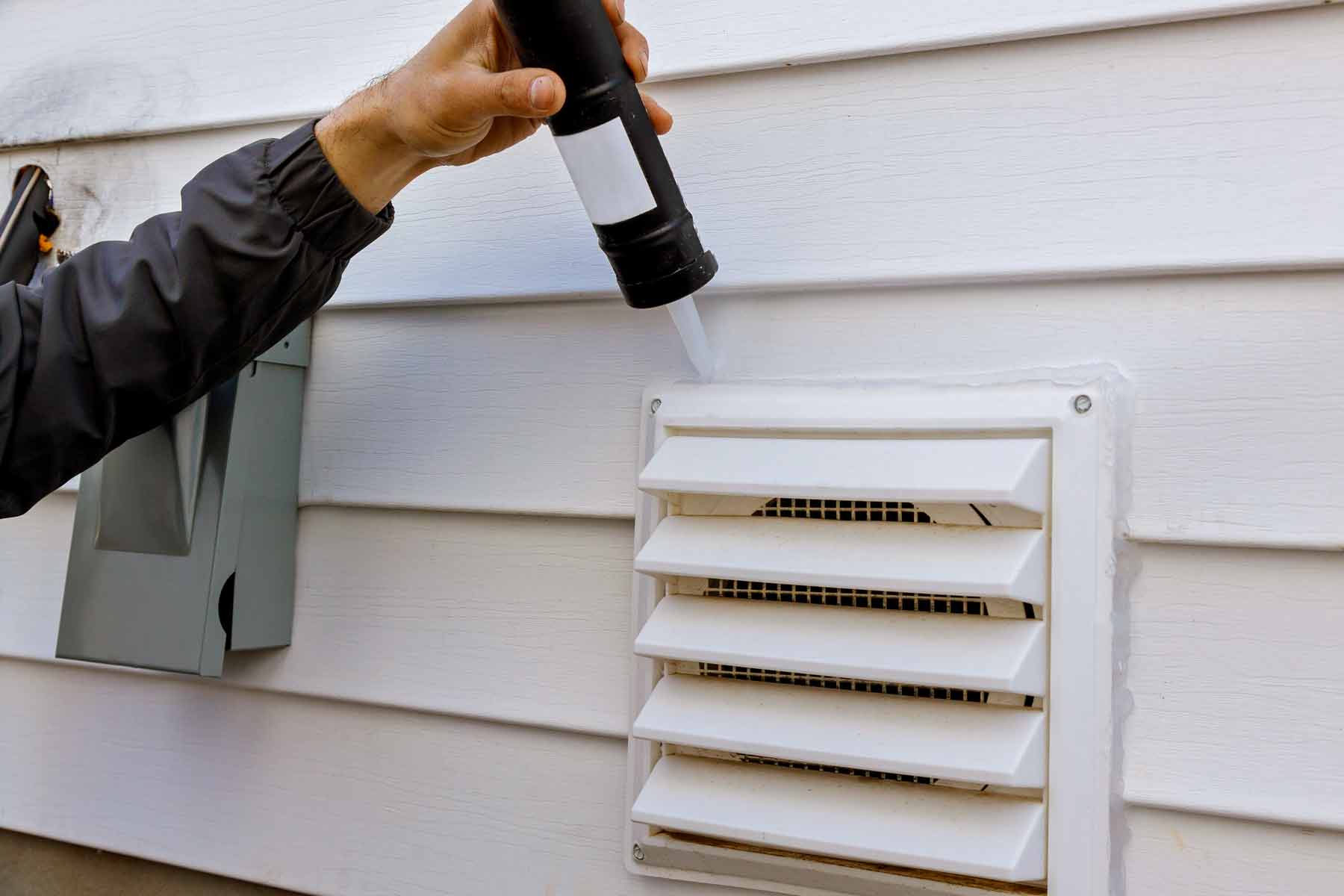 Professional installing a dryer vent cover